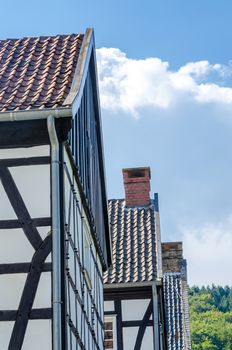 Idyllic, gable view of various half-timbered houses against a blue sky.