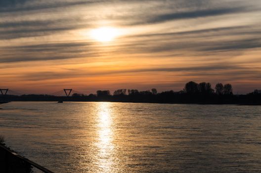 Beautiful sunset with reflection of the sun on the Rhine.