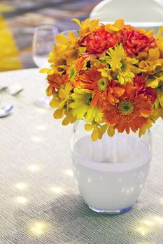 Flowers mixed bouquet in glass on the table