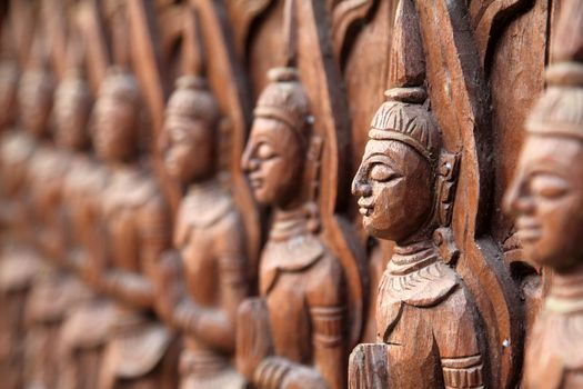 Closeup buddha wall of wood craft in temple, Thailand