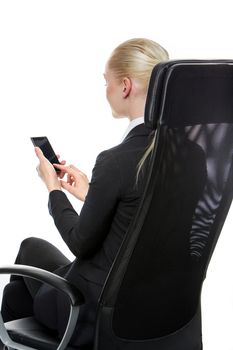 blonde smiling businesswoman seated on a chair with mobile phone