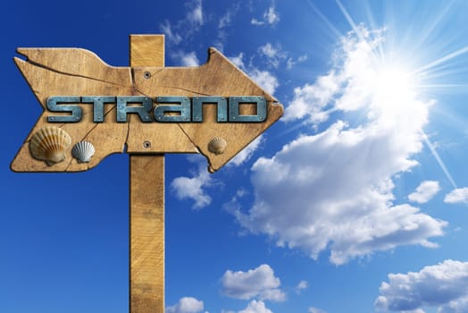 Wooden directional sign with one arrow, with text beach in german language and seashells on blue sky with clouds and sun rays