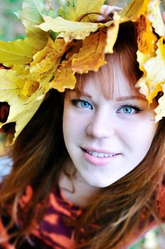 autumn redheaded gril with crown from leaves