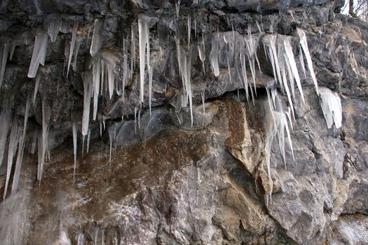 Icicle on stone inside cave tunnel