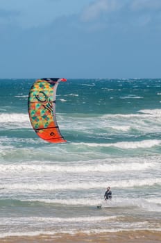 MOSSELBAY, SOUTH AFRICA - DECEMBER 31, 2014: A stormwind propels an unidentified windsurfer through the waves at the Klein Brakrivier beach