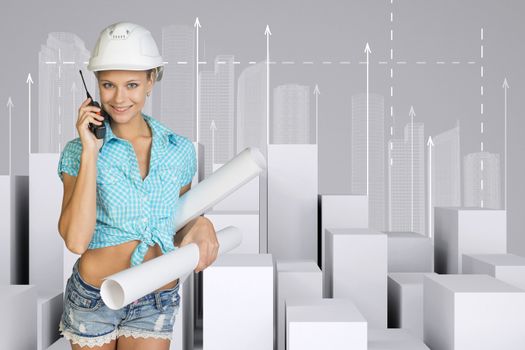 Beautiful girl in working clothes holding walkie-talkie and paper scrolls, looking at camera, smiling. Minimalistic city of white cubes with arrows on gray background