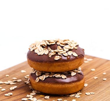 Delicious donuts on the wooden board