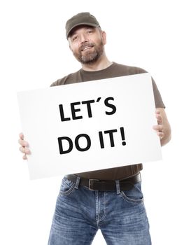 A bearded man holding a white board with the message let��s do it