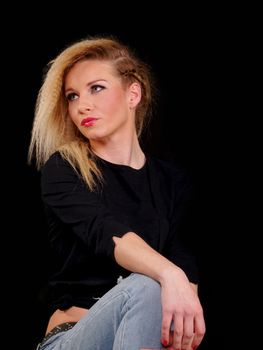 beautiful blonde woman in jeaans posing , studio shot