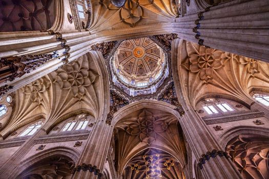 Stone Columns Dome Angels Statues New Salamanca Cathedral Spain.  The New and Old Cathedrals in Salamanca are right next to each other.  New Cathedral was built from 1513 to 1733 and commissioned by Ferdinand V of Castile, Spain.