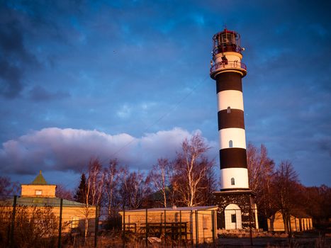 Ocean sunrise with lighthouse in Riga gulf, Baltic sea