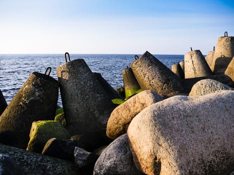 Daylight on the coast of the Riga Gulf at dawn with rocks in foreground