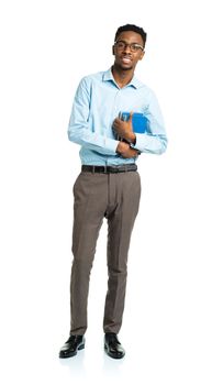 Happy african american college student with books standing on white background