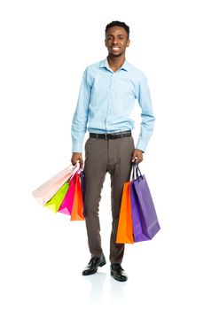 Happy african american man holding shopping bags on white background. Shoppind