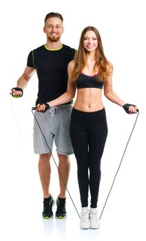 Happy athletic couple - man and woman with with ropes on the white background