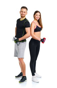 Sport couple - man and woman with dumbbells on the white background