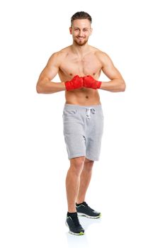 Athletic attractive man wearing boxing bandages on the white background