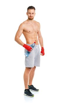 Athletic attractive man wearing boxing bandages with bottle of water on the white background