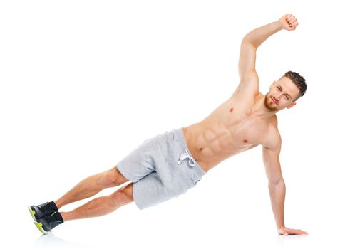Athletic attractive man doing fitness exercises on the white background