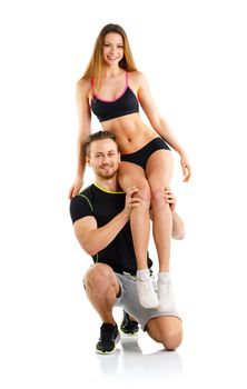 Sports guy holds on shoulder a girl on a white background