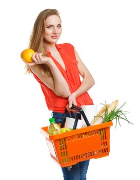 Happy young woman holding a basket full of healthy food. Shopping