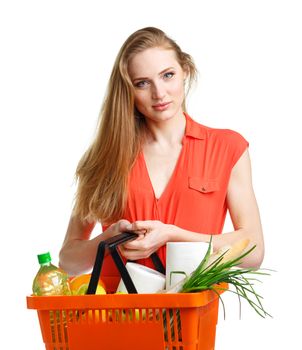 Happy young woman holding a basket full of healthy food. Shopping