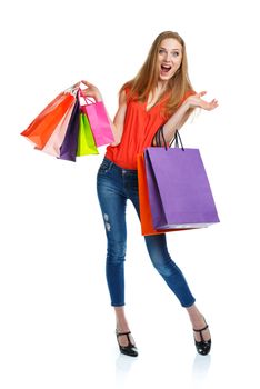 Happy lovely woman with shopping bags over white background