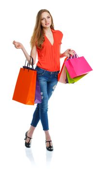 Happy lovely woman with shopping bags over white background