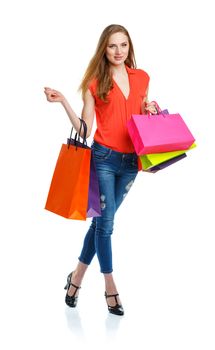 Happy lovely woman with shopping bags over white background