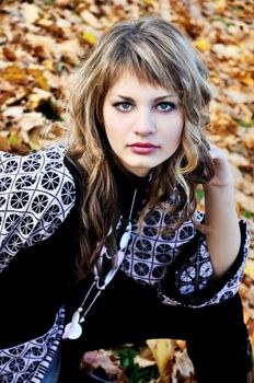 portrait of pretty teen girl in autumn park