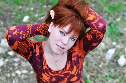 angle shoot of redheaded girl outdoors 