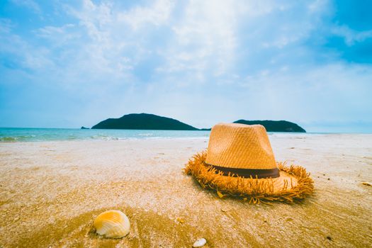 Hat and Shell on tropical beach