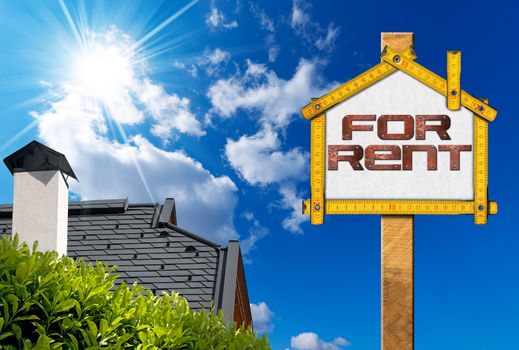 Yellow wooden meter ruler in the shape of house with text for rent. For rent real estate sign on blue sky with roof, clouds and sun rays