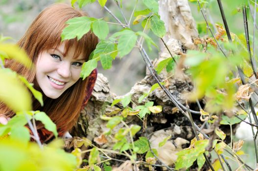 redheaded girl in forest in fall time