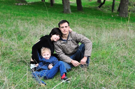 happy loving family in the forest during early autumn 