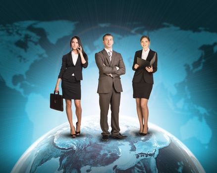 Business people standing on Earth surface. Background is world map with blue gradient. Elements of this image furnished by NASA
