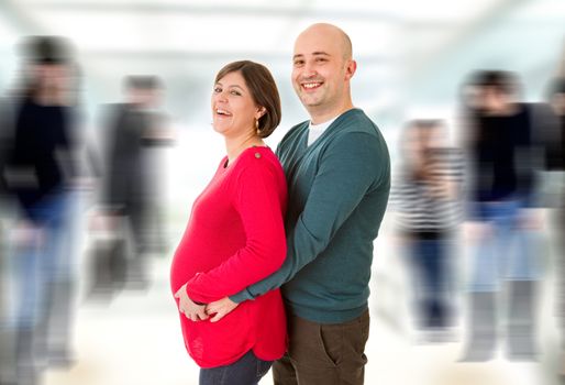 happy pregnant couple posing, studio picture