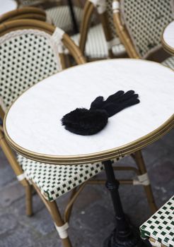 Forgotten Female Glove on a cafe table in Paris