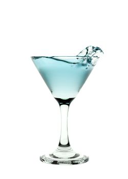 Green liquid splashing in a martini glass isolated on white background