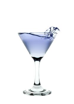 Blue liquid splashing in a martini glass isolated on white background