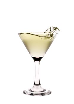 Yellow liquid splashing in a martini glass isolated on white background