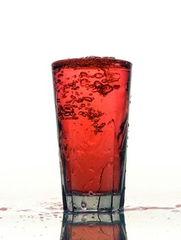 Glass of splashing Red lemonade isolated on white background