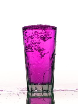 Glass of splashing Pink lemonade isolated on white background