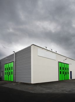Warehouse with green doors at dusk