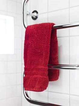 Red Towel on a dryer in modern bathroom environment