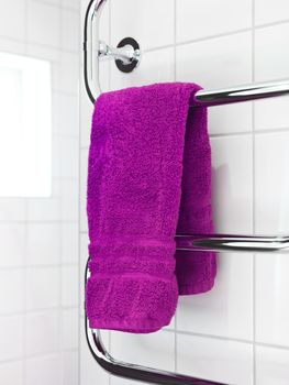 Pink Towel on a dryer in modern bathroom environment