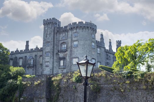 beautiful antique street lamp and riverside view of kilkenny castle in ireland