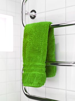Green Towel on a dryer in modern bathroom environment