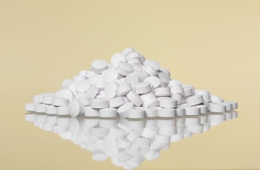 Stack of pills towards Yellow background