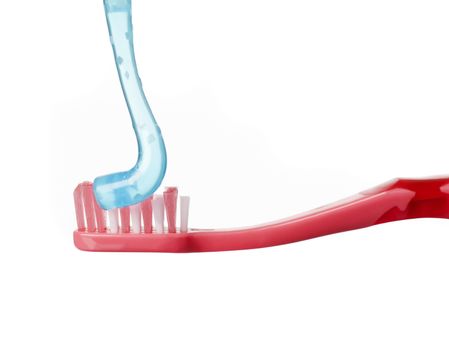 Red toothbrush and blue toothpaste isolated on white background